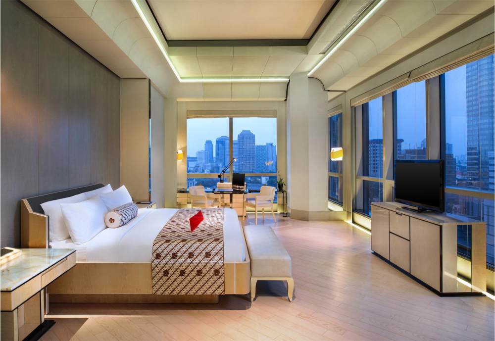 Junior Suite with floor to ceiling windows overlooking the city.jpg