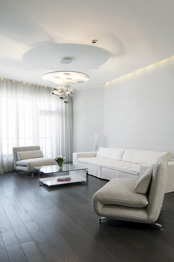 Living-Neutral-soft-furnishings-with-contrasting-dark-wood-floors-and-modern-lighting.jpg