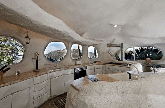 Flintstone-style-house-cave-rock-kitchen-round-windows-665x437.jpeg
