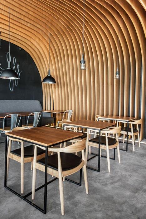 OOZN Design creates cavernous cafe in Jakarta using undulating timber slats_6-Degrees-Cafe-in-Indonesia-by-OOZN-Design_dezeen_2.jpg