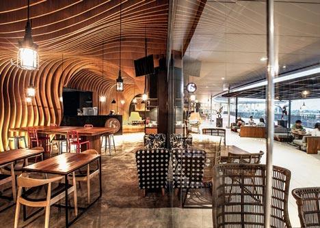 OOZN Design creates cavernous cafe in Jakarta using undulating timber slats_6-Degrees-Cafe-in-Indonesia-by-OOZN-Design_dezeen_7.jpg