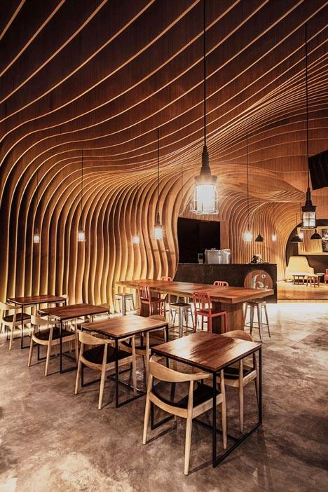 OOZN Design creates cavernous cafe in Jakarta using undulating timber slats_6-Degrees-Cafe-in-Indonesia-by-OOZN-Design_dezeen_8.jpg