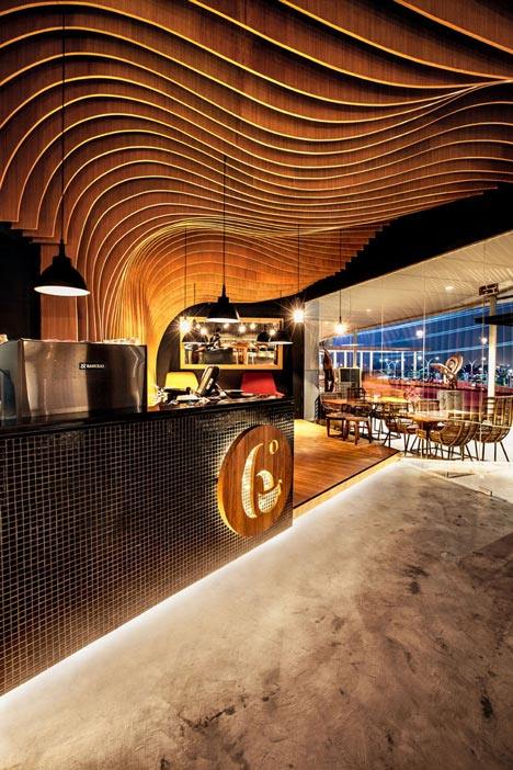 OOZN Design creates cavernous cafe in Jakarta using undulating timber slats_6-Degrees-Cafe-in-Indonesia-by-OOZN-Design_dezeen_10.jpg