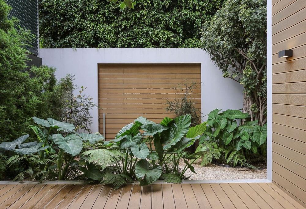 A Book Lover’s Dream House With Great Nature Views_shrouded-in-green-timber-garage.jpg