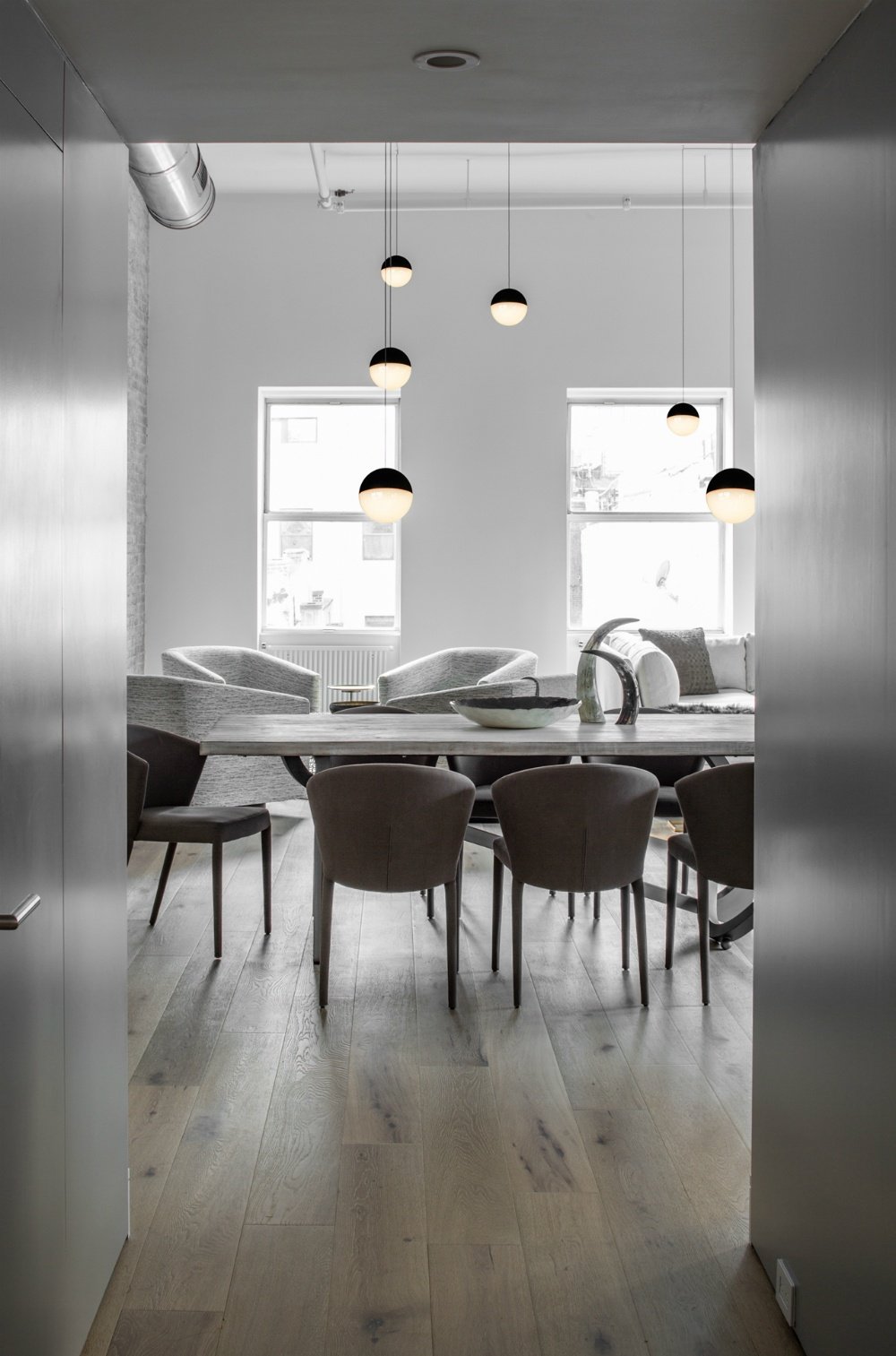 国外作品 | Decor Aid-ed: TriBeCa Loft Filled With Neutrals_Numerous-pendants-do-a-great-job-filling-up-all-that-air-between-the-furnishings-and-a-high-ceiling.jpg