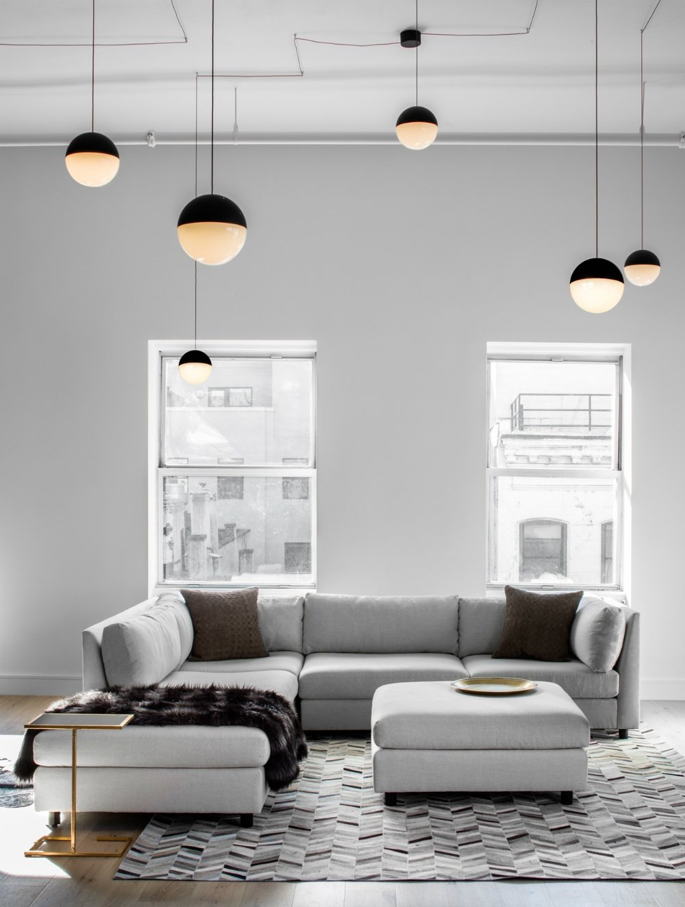 国外作品 | Decor Aid-ed: TriBeCa Loft Filled With Neutrals_The-living-area-enjoys-plenty-of-daylight-from-the-two-windows-behind-a-sectional-couch.jpg