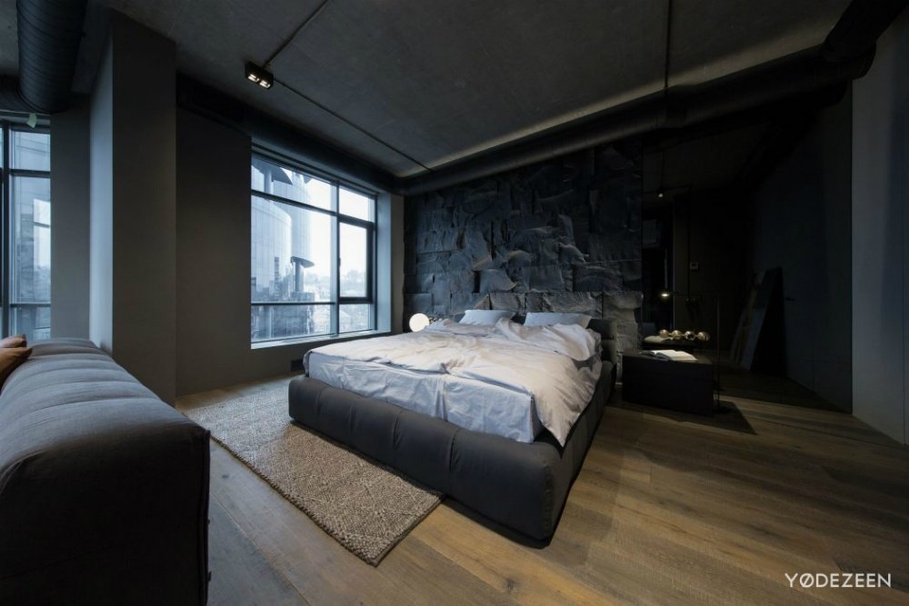 国外作品 | 基辅的黑暗公寓_Trendy-soft-bed-frame-provides-a-contrast-to-the-rough-stone-headboard-wall.jpg